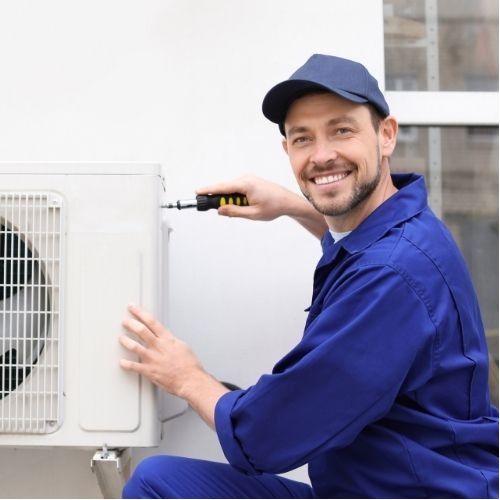 A heating engineer repairing a boiler